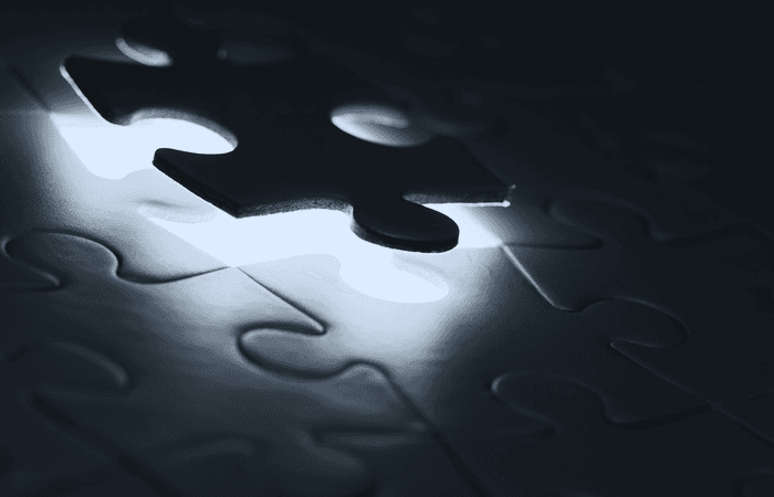 Puzzle piece fitting into puzzle